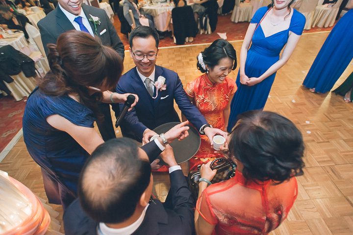 Tea pouring ceremony during a wedding reception at Mudan's. Captured by NYC wedding photographer Ben Lau.