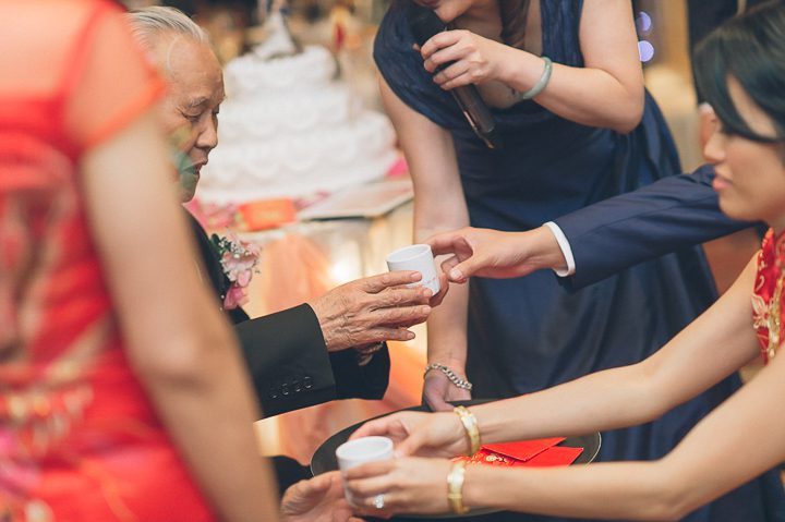 Tea pouring ceremony during a wedding reception at Mudan's. Captured by NYC wedding photographer Ben Lau.