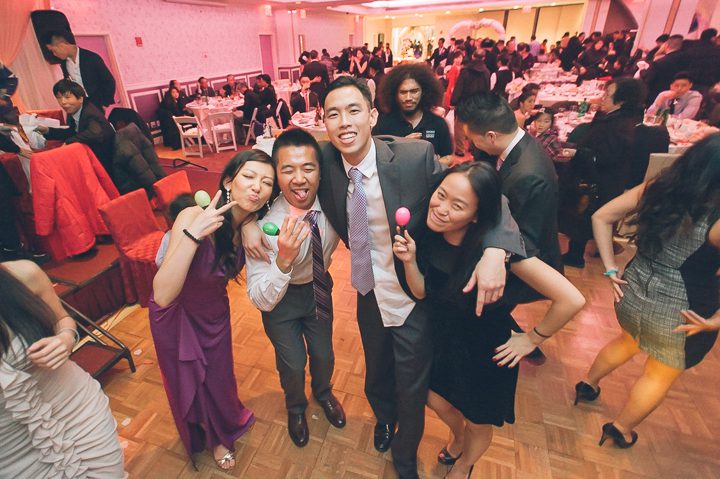 Guests pose for photos during a wedding reception at Mudan's in Flushing Queens. Captured by NYC wedding photographer Ben Lau.