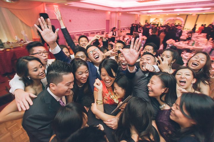 Guests dance during a wedding reception at Mudan's in Flushing Queens. Captured by NYC wedding photographer Ben Lau.