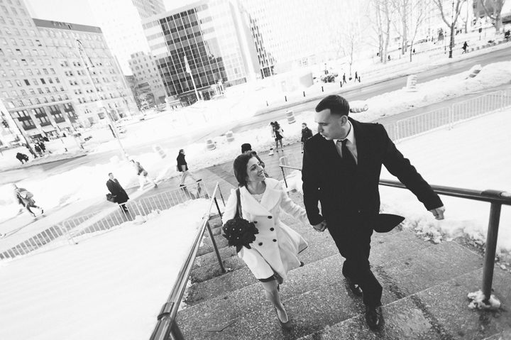 Couple ascends the stairs to the courthouse. Captured by NYC City Hall Wedding Photographer Ben Lau.