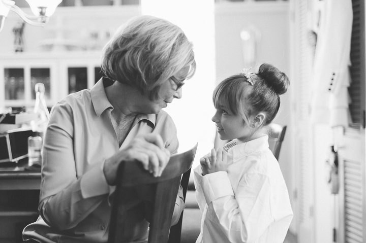 Flower girl talks to her grandmother on the morning of a wedding at the Westmount Country Club. Captured by Northern NJ wedding photographer Ben Lau.