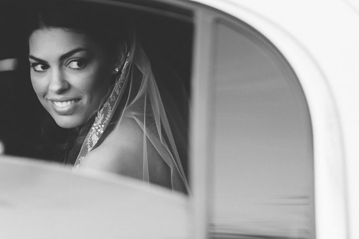 Bride looks out of the window. Captured by Northern NJ wedding photographer Ben Lau.