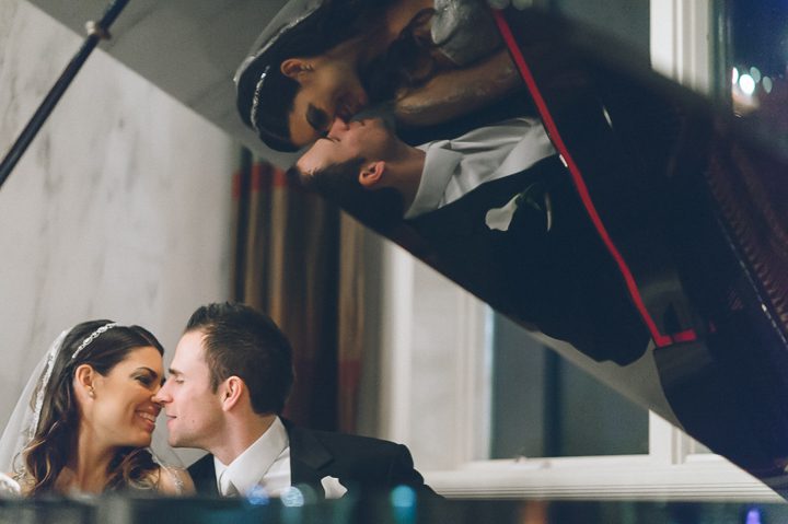 Bride and groom behind a piano at the Westmount Country Club. Captured by Northern NJ wedding photographer Ben Lau.