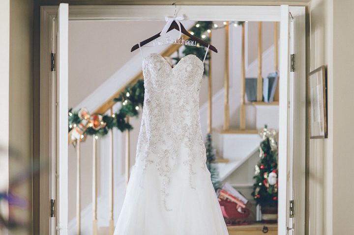 Wedding dress hangs in the foyer for a Westmount Country Club wedding. Captured by Northern NJ wedding photographer Ben Lau.