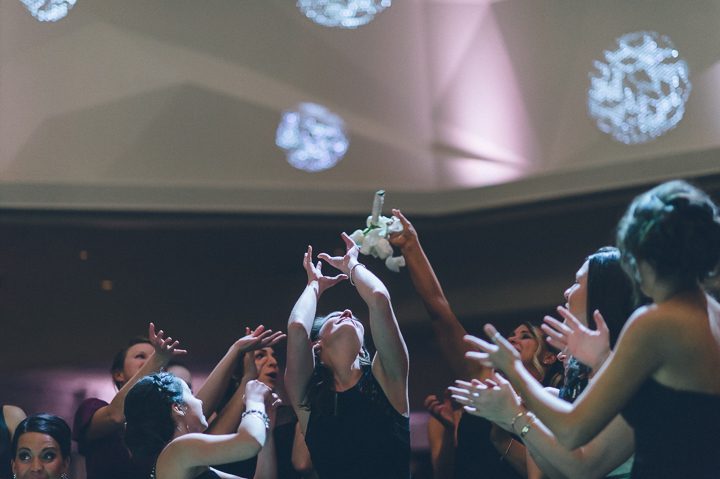 Bouquet toss during a wedding reception at the Westmount Country Club. Captured by Northern NJ wedding photographer Ben Lau.
