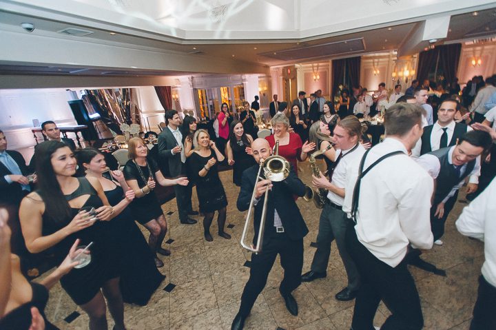 Trombonist plays for guests during a wedding reception at the Westmount Country Club. Captured by Northern NJ wedding photographer Ben Lau.