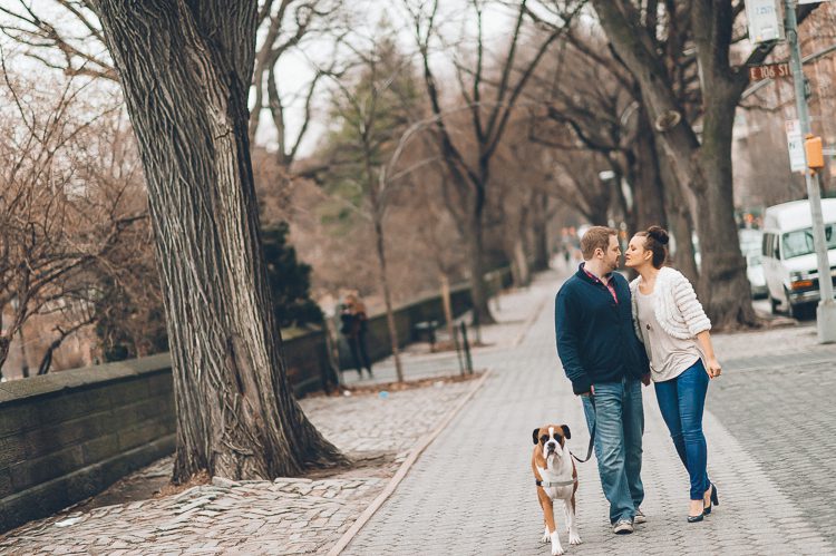 Couple share a kiss on their walk home during their engagement session in Central Park. Captured by NYC wedding photographer Ben Lau.