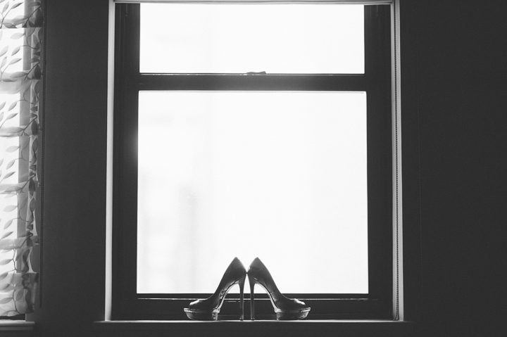 Wedding shoes by the window at the Essex House in NYC. Captured by NYC wedding photographer Ben Lau.