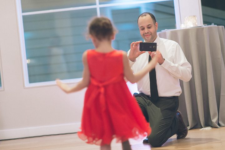 Groom photographs his daughter at the Maritime Parc in Jersey City, NJ. Captured by NYC wedding photographer Ben Lau.