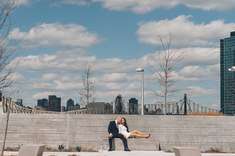 Newly married couple poses at Gantry Plaza State Park for their wedding photos. Captured by NYC City Hall wedding photographer Ben Lau.