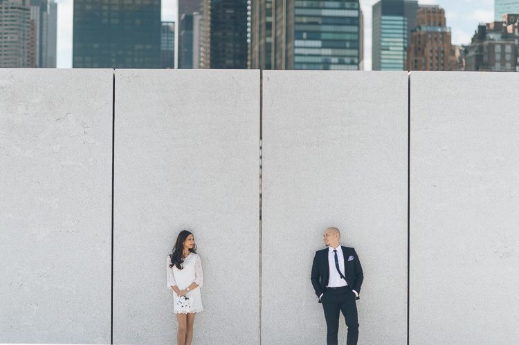 Newly married couple poses at Roosevelt Island for their wedding photos. Captured by NYC City Hall wedding photographer Ben Lau.
