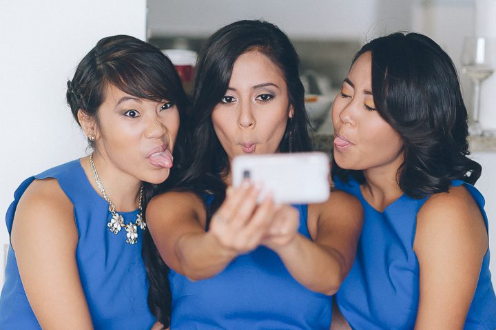 Bridemaids take a selfie on the morning of a wedding day at the Sonesta Bayfront Hotel in Coconut Grove, Miami. Captured by Miami wedding photographer Ben Lau.