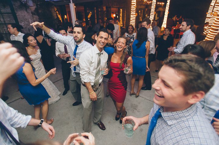 Guests pose for photos during a wedding reception at the Red Fish Grill in Miami, FL. Captured by Miami wedding photographer Ben Lau.