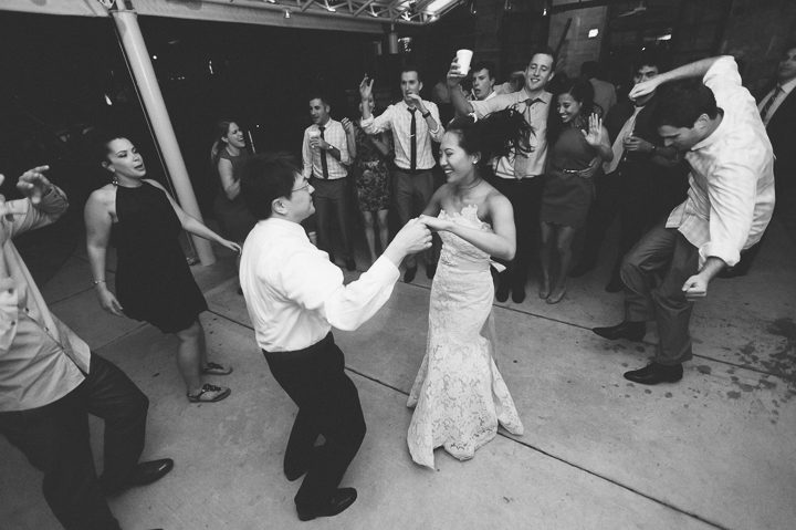 Guests dance during a wedding reception at the Red Fish Grill in Miami, FL. Captured by Miami wedding photographer Ben Lau.