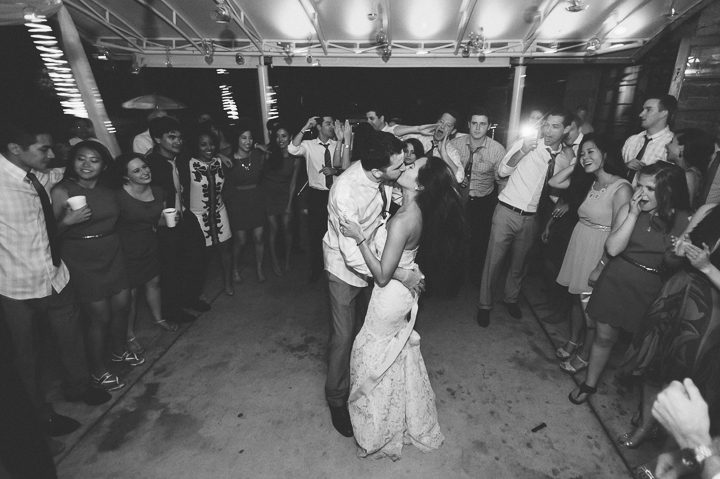 Bride and groom kiss during their wedding reception at the Red Fish Grill in Miami, FL. Captured by Miami wedding photographer Ben Lau.
