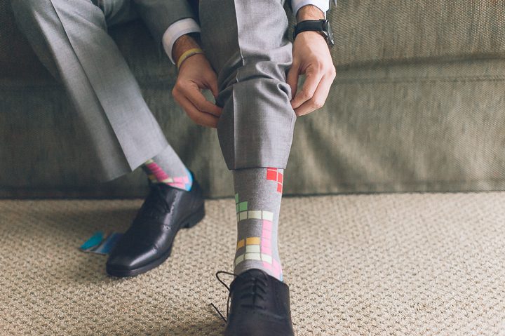 Groom put son his colorful socks on the morning of his wedding day at the Sonesta Bayfront Hotel in Coconut Grove, Miami. Captured by Miami wedding photographer Ben Lau.