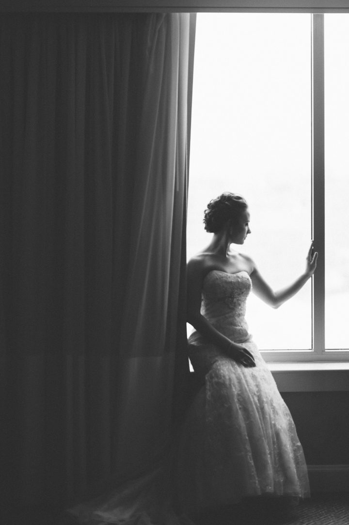 Bride sits by the window at the Franklin Institute in Philadelphia. Captured by NYC wedding photographer Ben Lau.