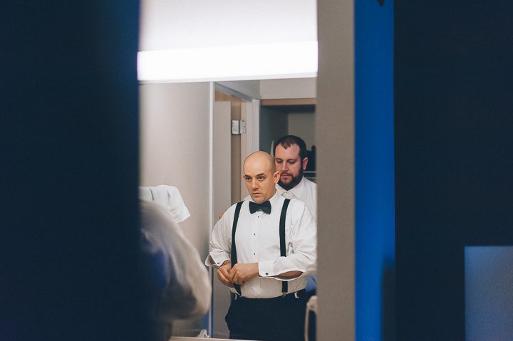 Groom preps for his wedding at the Franklin Institute in Philadelphia. Captured by NYC wedding photographer Ben Lau.