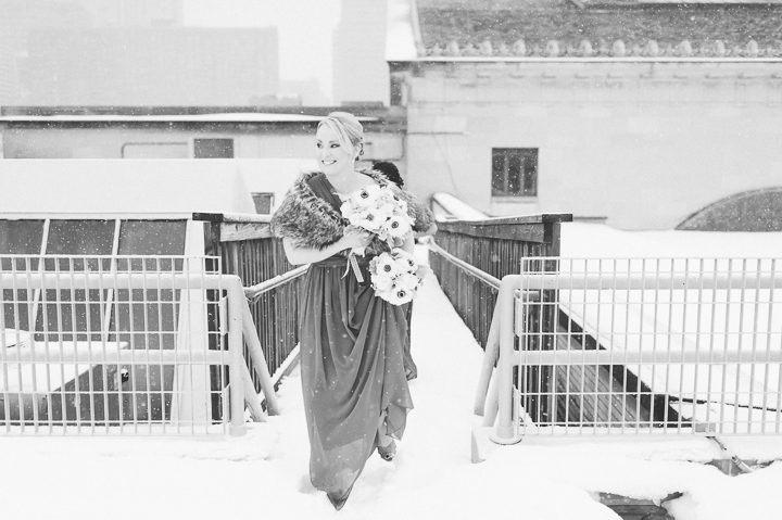 Winter bridesmaid walks onto the roof top of the Franklin Institute in Philadelphia. Captured by NYC wedding photographer Ben Lau.