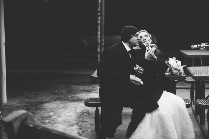 Couple shares a Philly cheesesteak after their wedding. Captured by NYC wedding photographer Ben Lau.