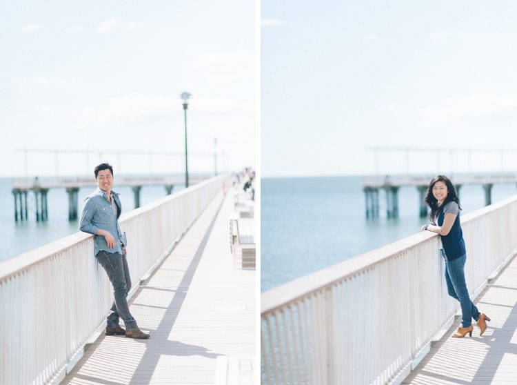Couple poses on the boardwalk during their engagement session in Coney Island. Captured by NYC wedding photographer Ben Lau.