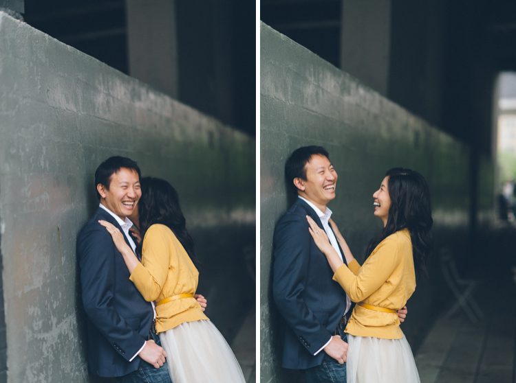 Couple laughs together during their engagement session at the High Line in NYC. Captured by NYC wedding photographer Ben Lau.
