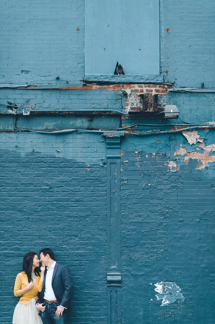 A couple shares a moment together during their engagement session at the High Line in NYC. Captured by NYC wedding photographer Ben Lau.