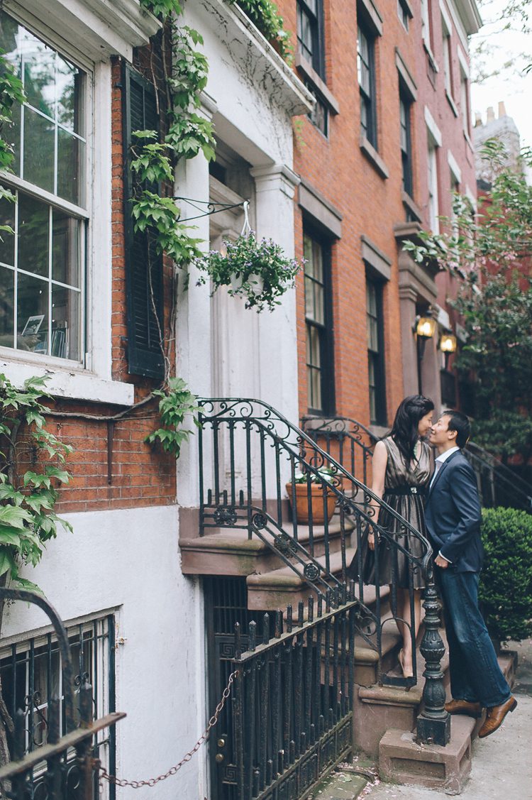 Alyssa and Gary share a kiss during their engagement session in the West Village in NYC. Captured by NYC wedding photographer Ben Lau.