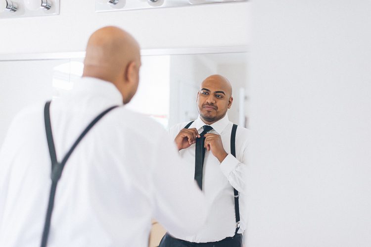 Groom preps on the morning of his wedding at Normandy Farms in Blue Bell, PA. Captured by Philadelphia wedding photographer Ben Lau.