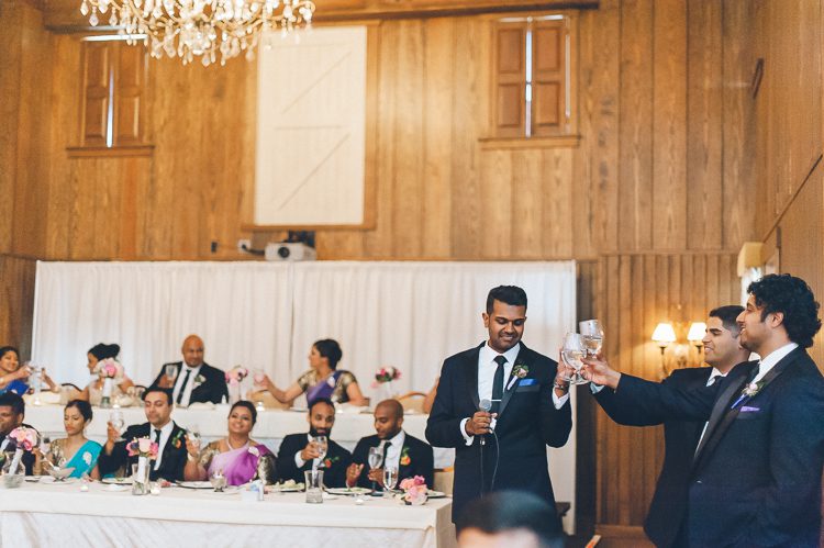 Toasts during a wedding reception at Normandy Farms in Blue Bell, PA. Captured by Philadelphia wedding photographer Ben Lau.