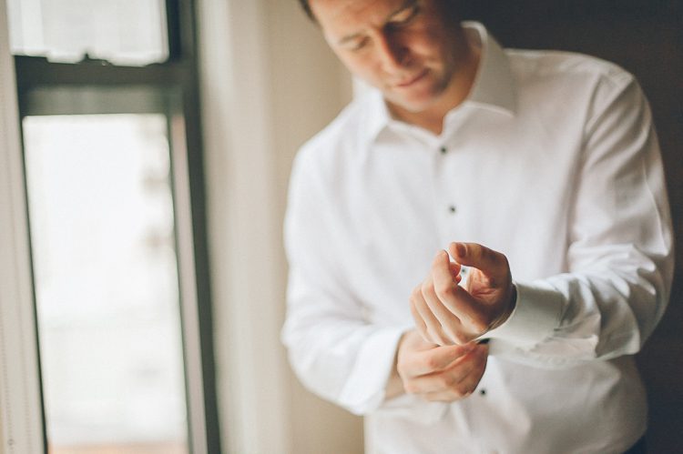 Groom preps for his wedding day at Pier 60 & The Lighthouse. Captured by NYC wedding photographer Ben Lau.