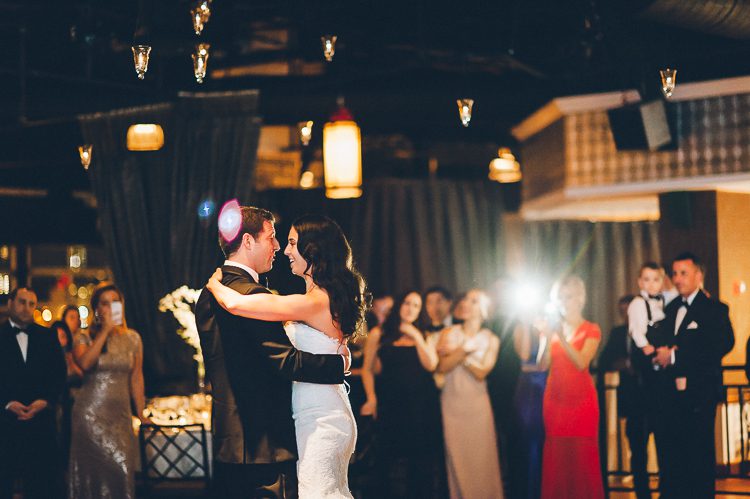 Bride and groom's first dance during a wedding reception at Pier 60 and the Light House. Captured by NYC wedding photographer Ben Lau.