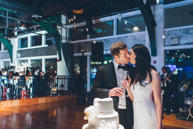 Cake cutting during a wedding reception at Pier 60 and the Light House. Captured by NYC wedding photographer Ben Lau.
