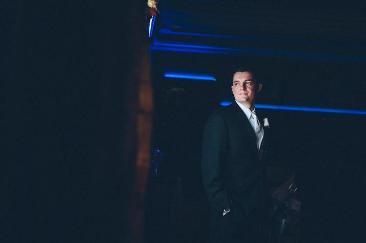 Window lit groom's portrait at The Palace at Somerset Park. Captured by Northern NJ wedding photographer Ben Lau.