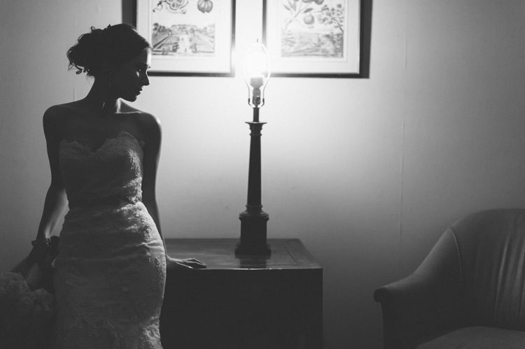 Bride poses in a dark room on her wedding day at The Palace at Somerset Park. Captured by Northern NJ wedding photographer.