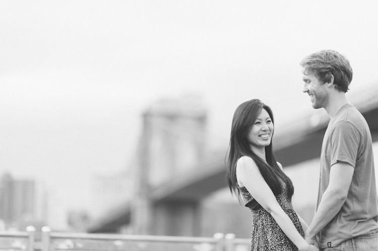Laura & Jason during their engagement session in DUMBO Brooklyn. Captured by NYC wedding photographer Ben Lau.