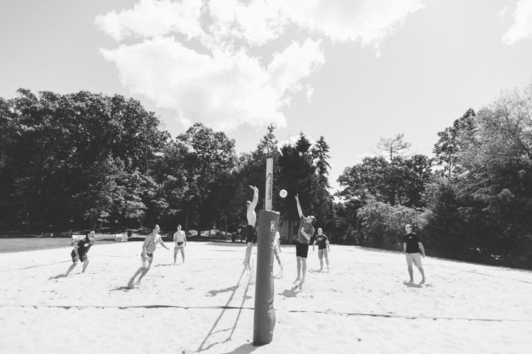 Groom and groomsmen play volleyball at the Lake Valhalla Club in Montville, NJ. Captured by NJ wedding photographer Ben Lau.