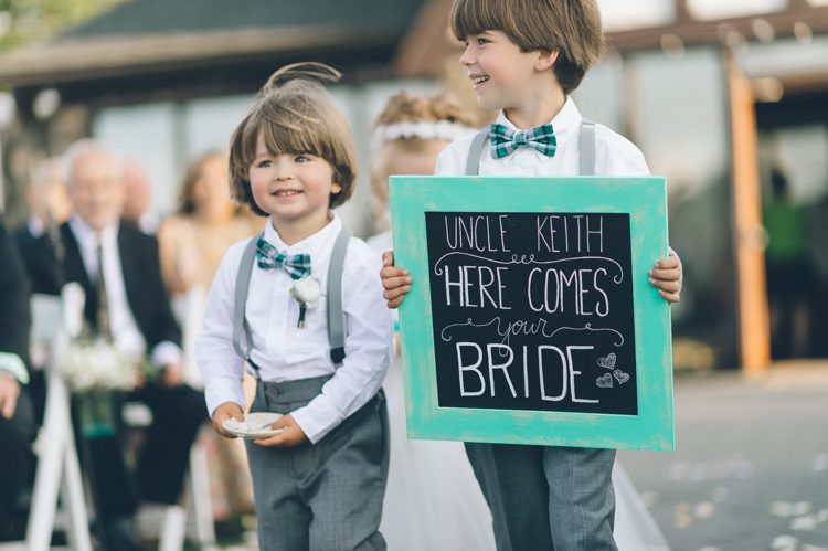 Ring bearers walk down the aisle during a wedding ceremony at the Lake Valhalla Club in Montville, NJ. Captured by NJ wedding photographer Ben Lau.