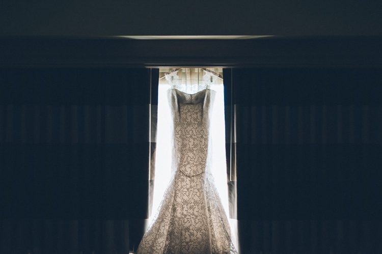 Wedding dress in hotel room in Jersey City. Captured by NYC wedding photographer Ben Lau.