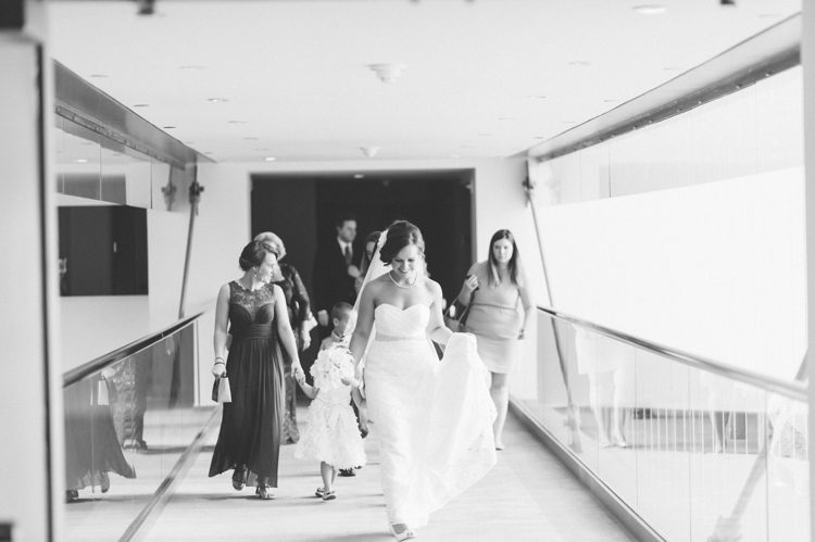 Bride leaving the Conrad hotel, on her way to her wedding at Trinity Church. Captured by NYC wedding photographer Ben Lau.