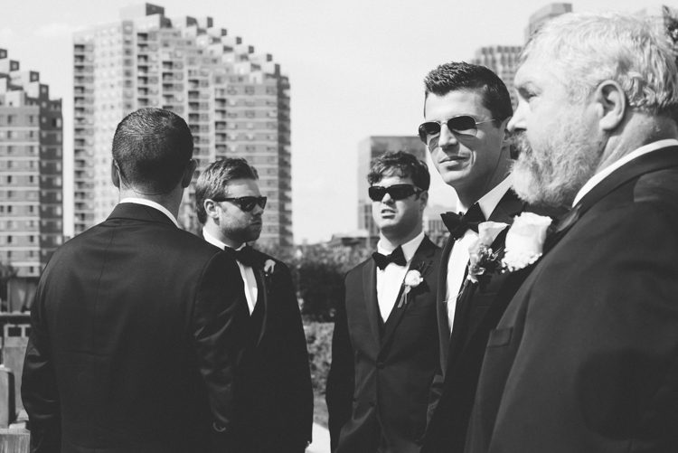Groomsmen prepare for a wedding at the LIberty House in Jersey City, NJ. Captured by awesome NJ wedding photographer Ben Lau.