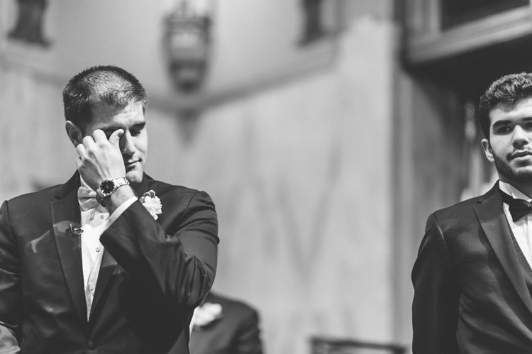 Groom cries during his wedding ceremony at St. Andrew Avellino Church. Captured by NYC wedding photographer Ben Lau.