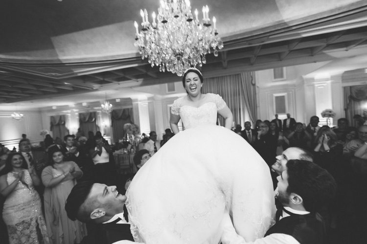 Bride's chair dance during her wedding at the Inn at New Hyde Park. Captured by NYC wedding photographer Ben Lau.
