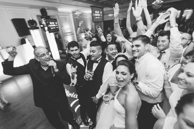 Guests dance during a wedding at the Inn at New Hyde Park. Captured by NYC wedding photographer Ben Lau.