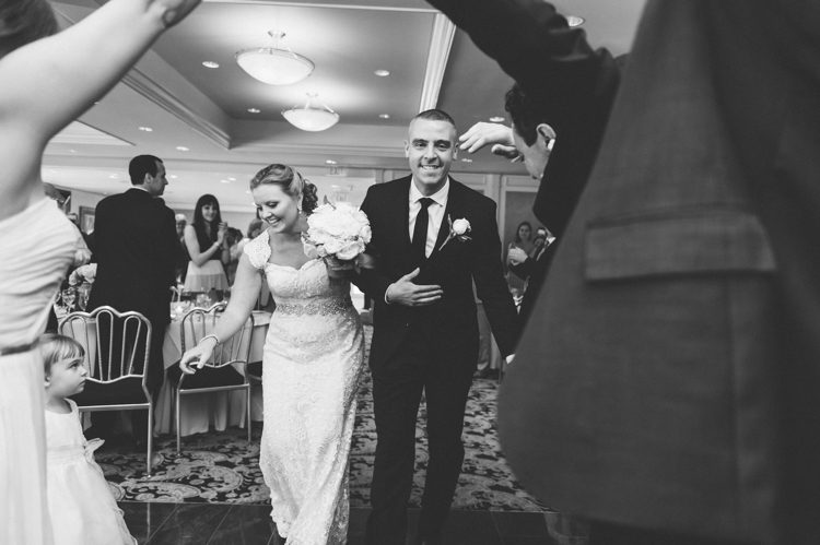 Bride and groom make a grand entrance during their wedding reception at The Mill in Spring Lake Heights. Captured by North Jersey wedding photographers at Ben Lau Photography.