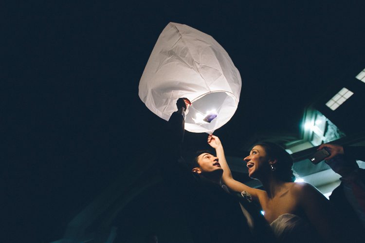 Bride and groom release a candle lantern at the conclusion of their Rock Island Country Club wedding in Sparta, NJ. Captured by Karis of Ben Lau Photography.