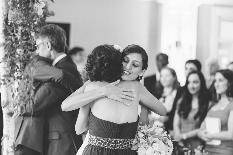 Bride hugs her mother during a Rock Island Lake Club Wedding in Sparta, NJ. Captured by NJ wedding photographer Ben Lau.