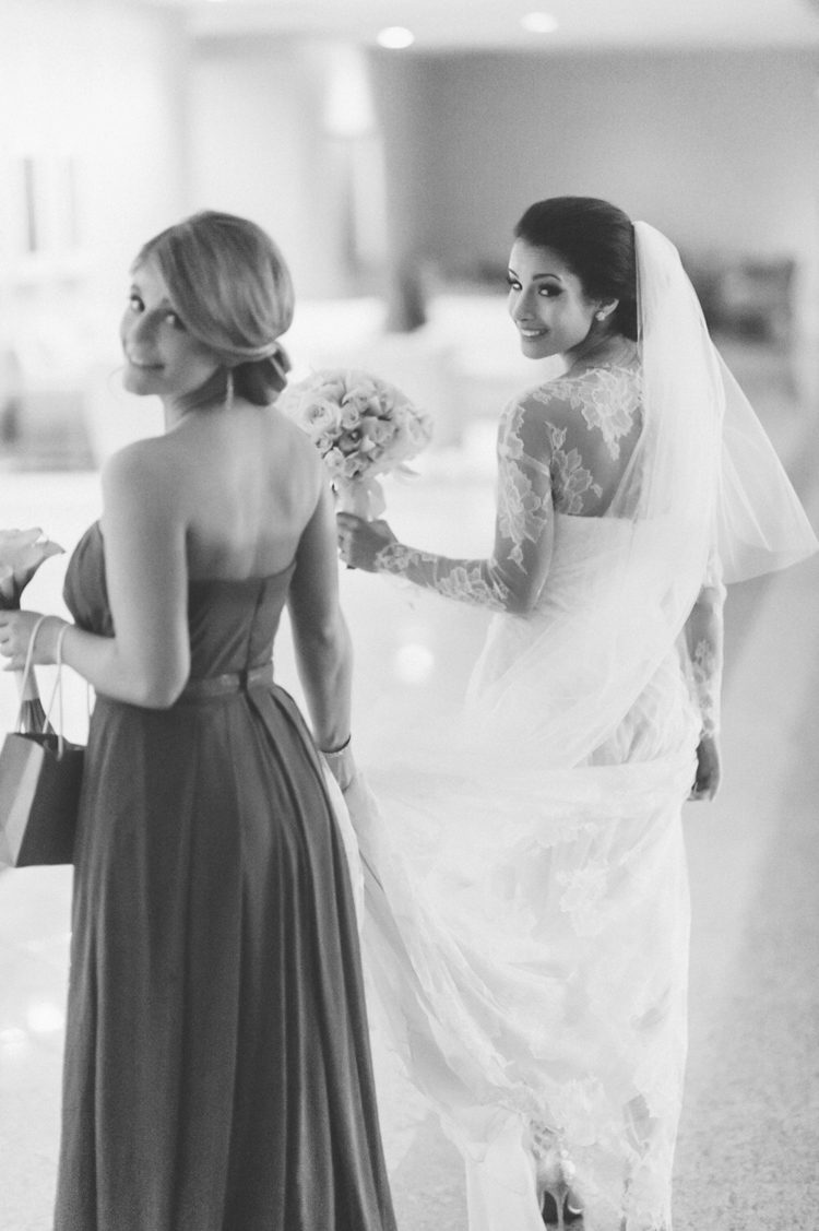 Candid of bride and her bridesmaid on the morning of her Seaport Hotel wedding in Boston, MA. Captured by NYC wedding photographer Ben Lau.