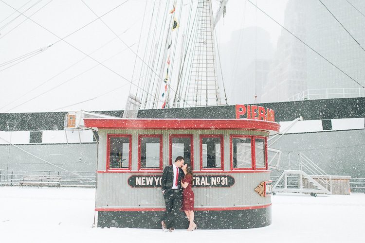 Snowy engagement session in South Street Seaport, captured by fun NYC wedding photographer Ben Lau Photography.